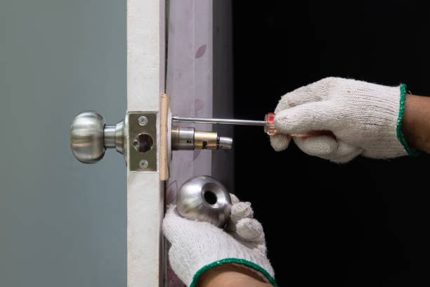 Locksmith repairing a front door lock