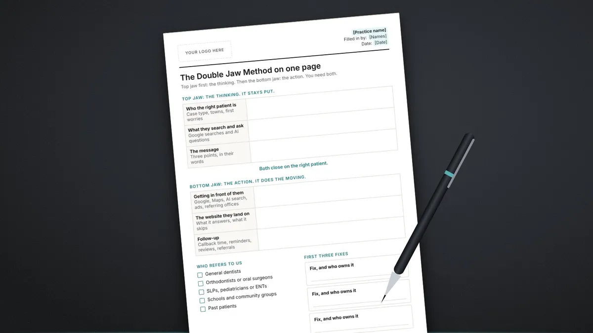 The printed Double Jaw Method worksheet on a dark desk beside a pen, with the top jaw and bottom jaw sections and a who-refers-to-us checklist.