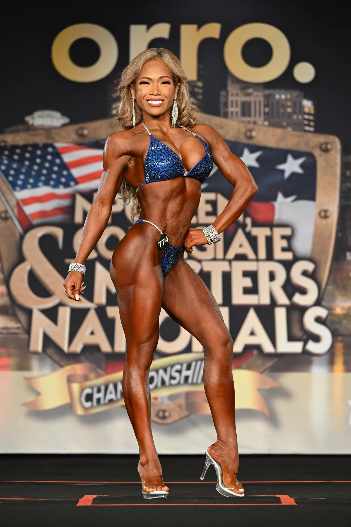 Picture of Joy in Blue comp suit posing on stage 