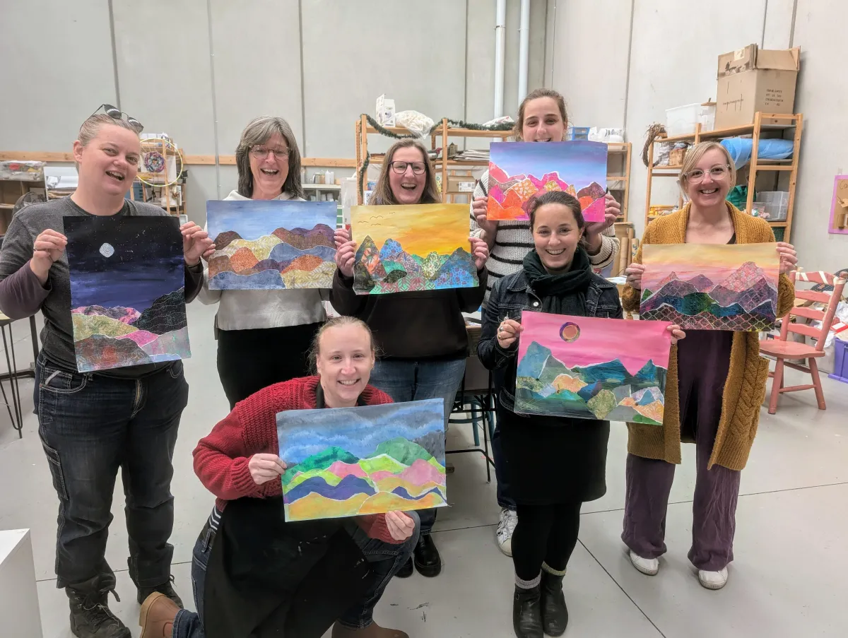 A bright lifestyle scene showing a single parent’s hands arranging colorful craft supplies on a table, natural daylight from a nearby window, candid warm mood, photorealistic editorial style, family-friendly atmosphere.