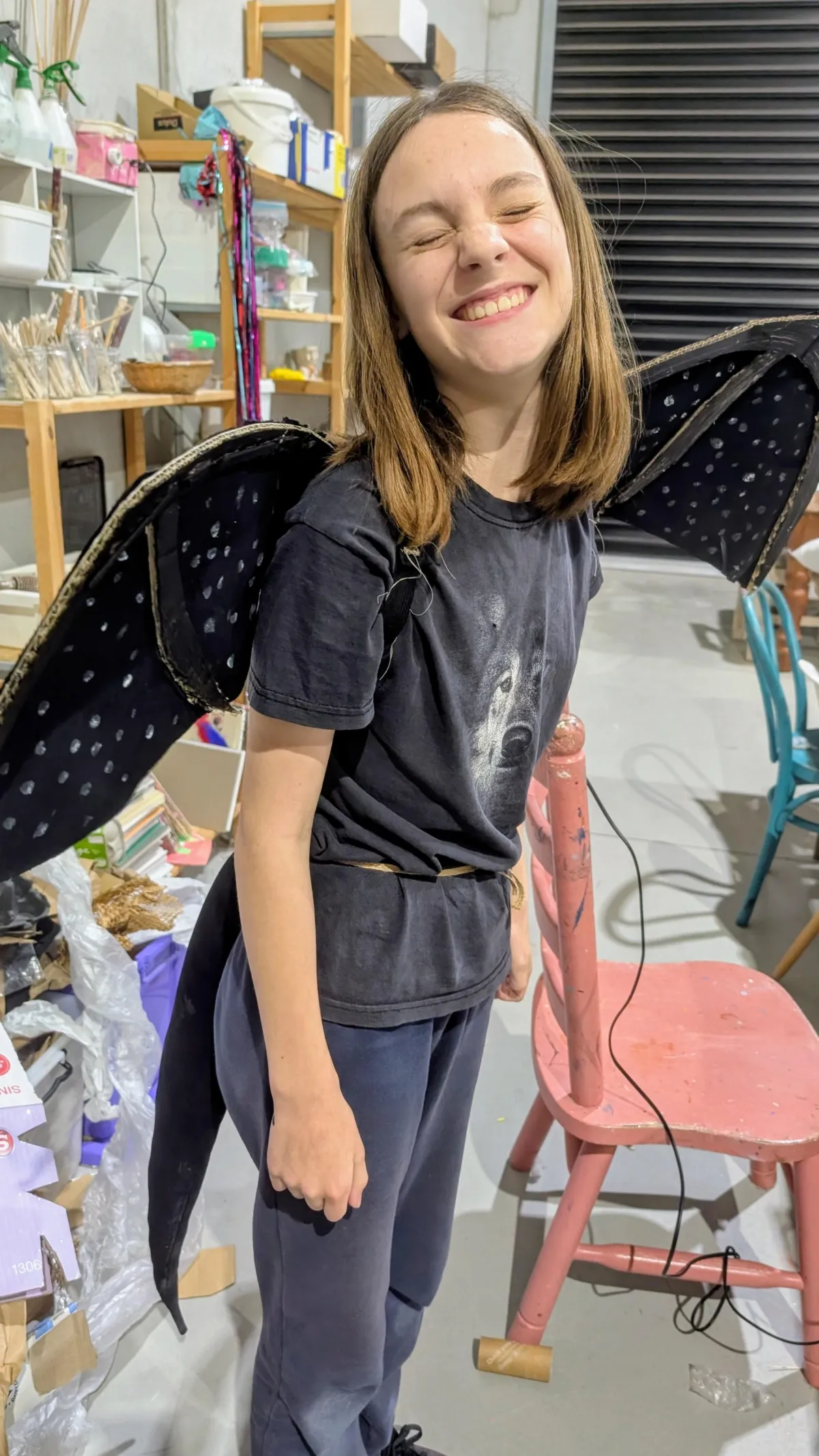 A bright lifestyle scene showing a single parent’s hands arranging colorful craft supplies on a table, natural daylight from a nearby window, candid warm mood, photorealistic editorial style, family-friendly atmosphere.