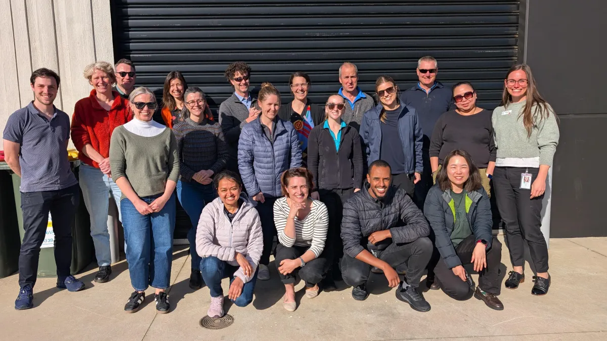 A bright lifestyle scene showing a single parent’s hands arranging colorful craft supplies on a table, natural daylight from a nearby window, candid warm mood, photorealistic editorial style, family-friendly atmosphere.