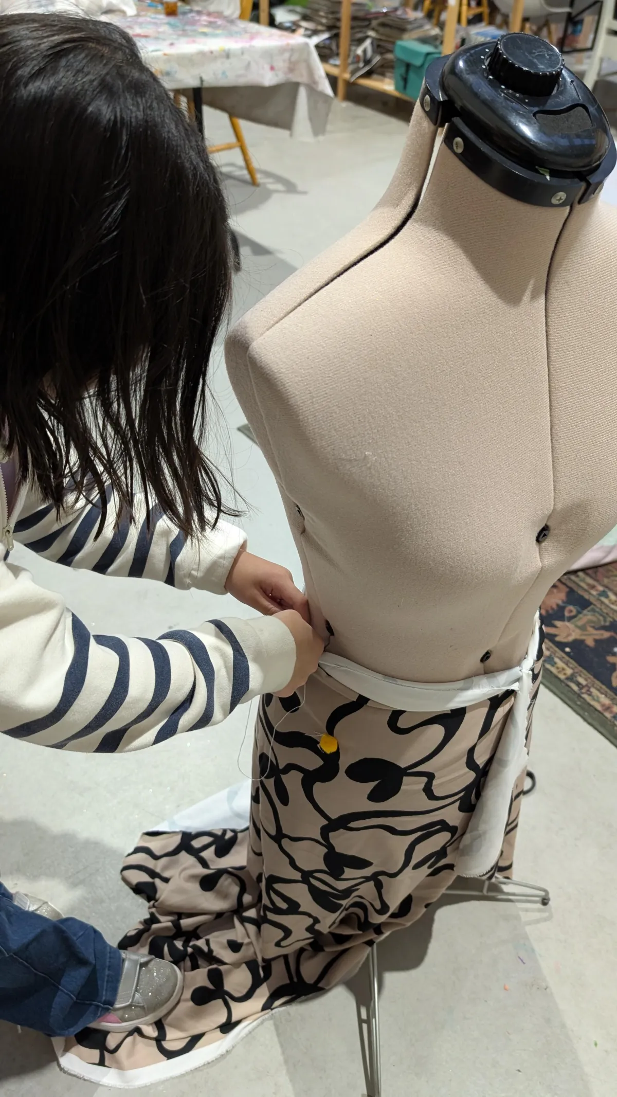 Portrait of a smiling mother holding a framed child collage