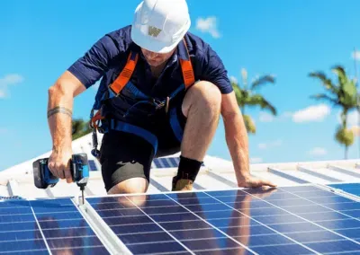 A proficient solar installer securely attaching a solar panel to a roof with precision and expertise. This skilled professional ensures a seamless integration of the solar panel onto the roof's surface, maximizing exposure to the sun's rays. Witness the transformation of rooftops into clean energy powerhouses as solar panels are meticulously installed, enabling homeowners to embrace sustainable energy solutions. Experience the benefits of solar energy with our trusted solar panel installation services.