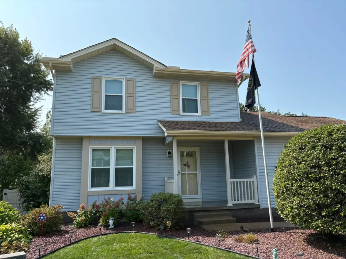 A blue house shines brilliantly following a fresh cleaning from Slick's Power Wash. 