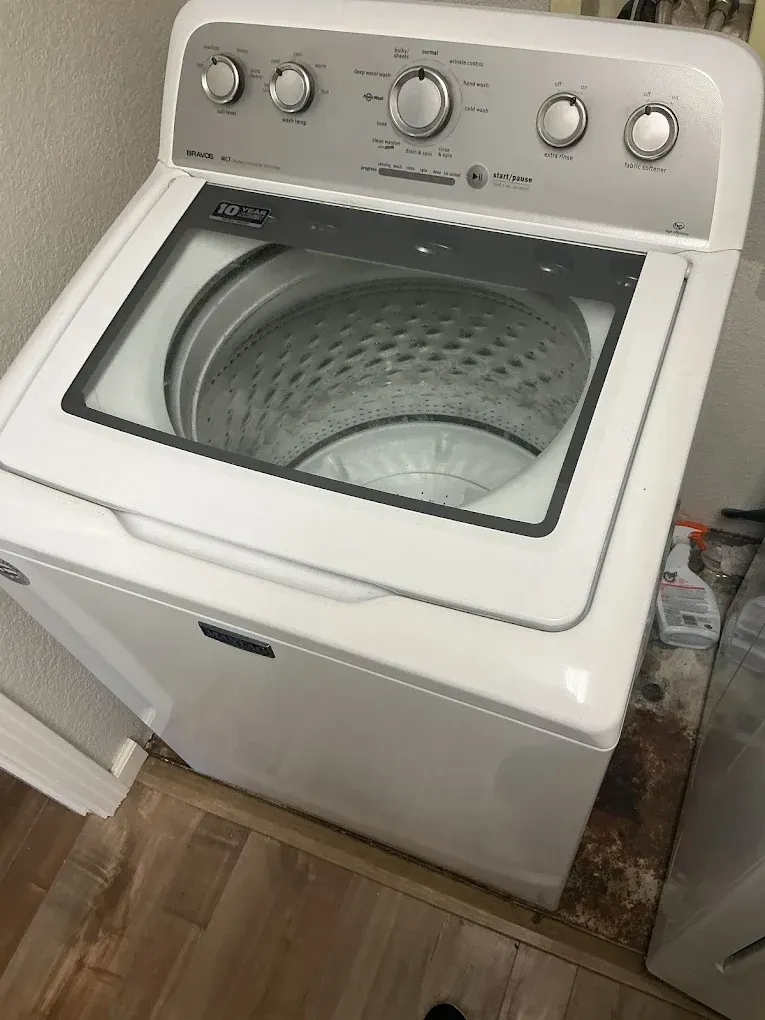 Factory-certified repair technician replacing the heating element drum assembly on a residential clothes dryer in Modesto, CA near the Vintage Faire Mall district.