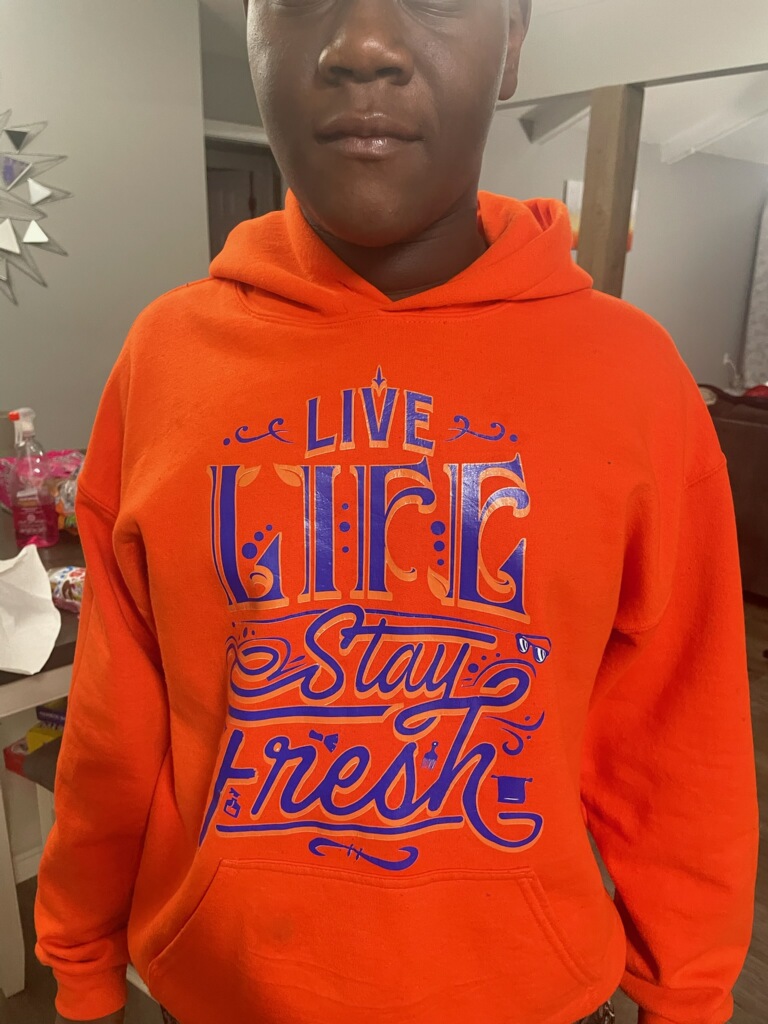 Lifestyle shot of Live Life Stay Fresh apparel worn in the city
