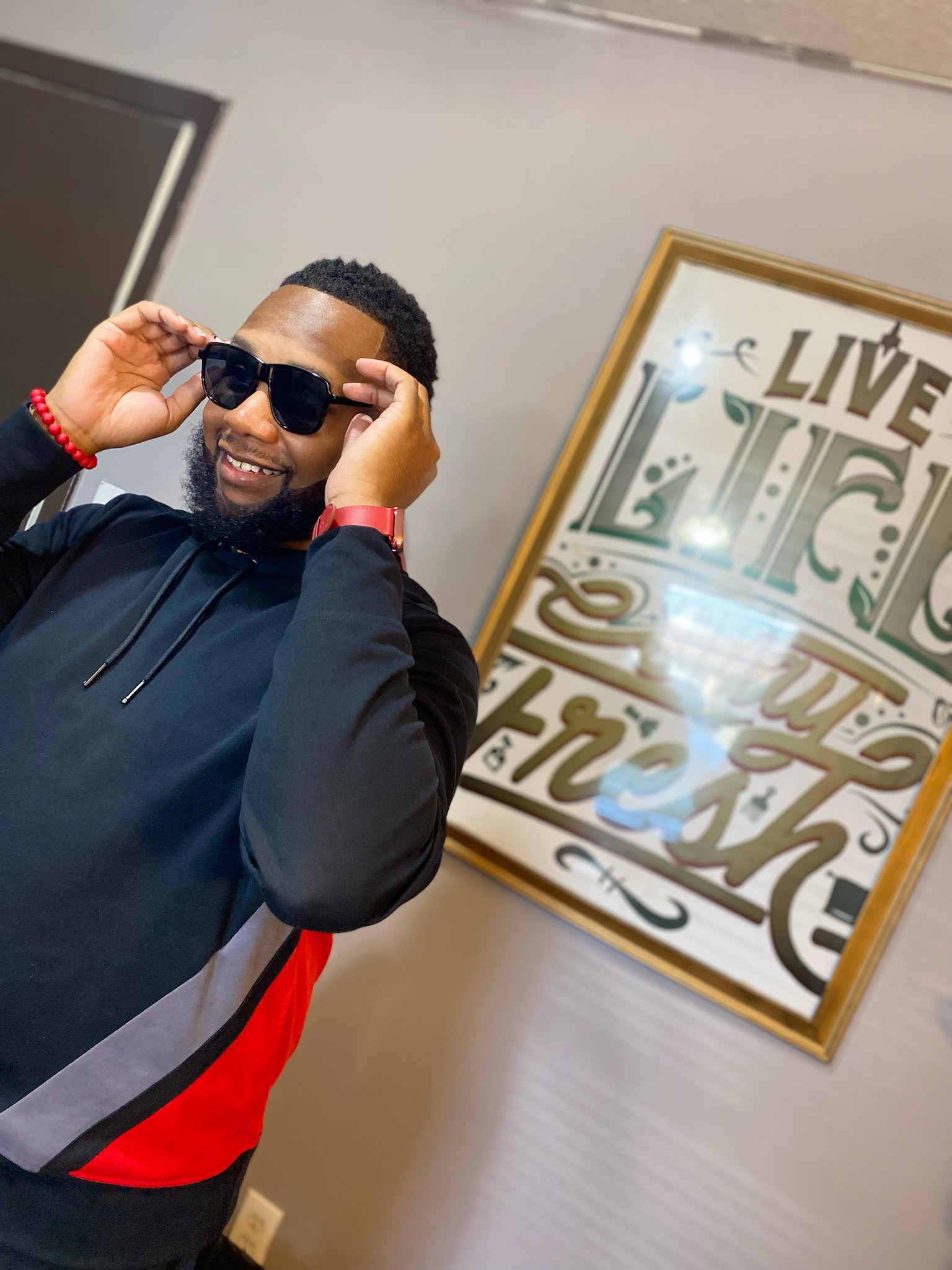 Barbers laughing and talking with clients in the shop