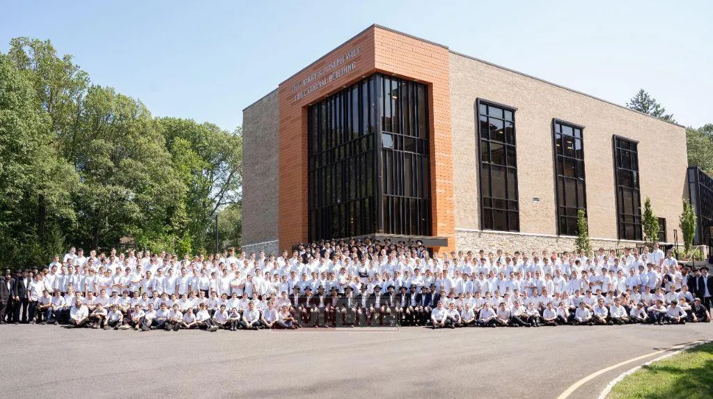 A very tall building with a sign on top of it