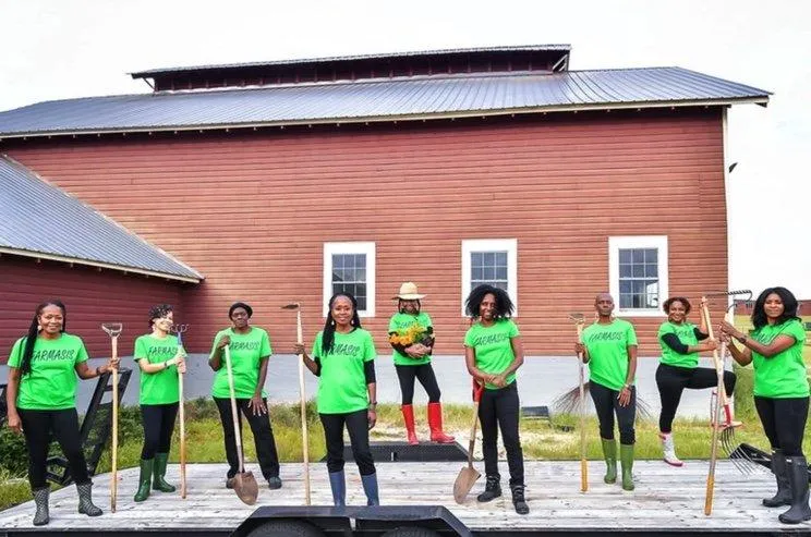 FarmaSis participants with green shirts standing on the back of a trailer