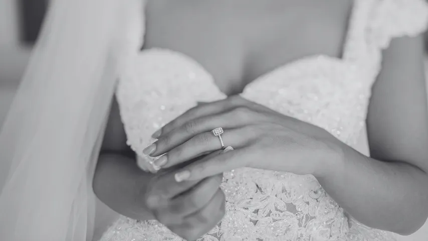 A Bride in a white dress with a ring on her finger