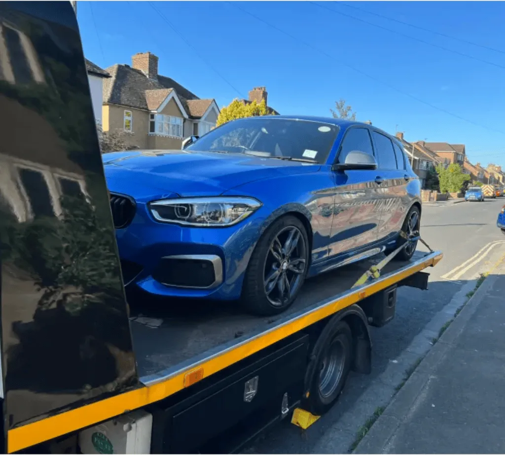A new blue BMW being delivered by our tow truck