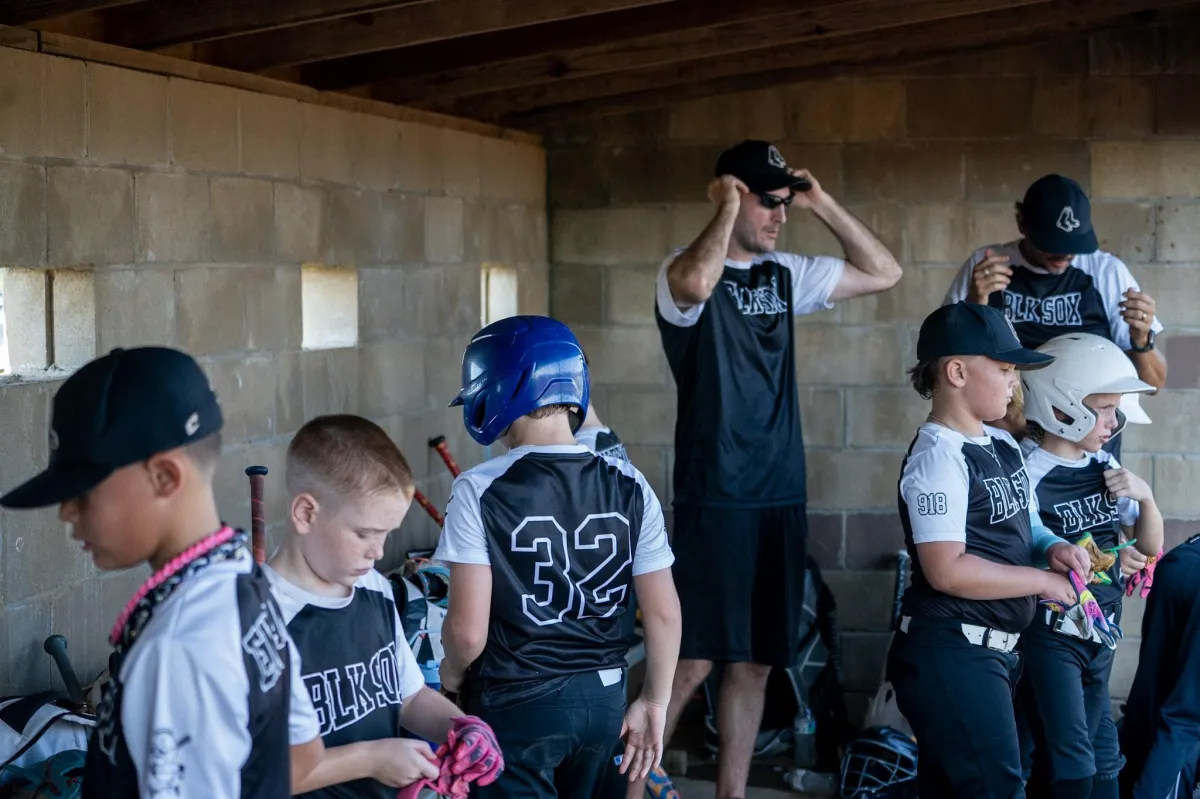 a group of young boys playing a game of baseball