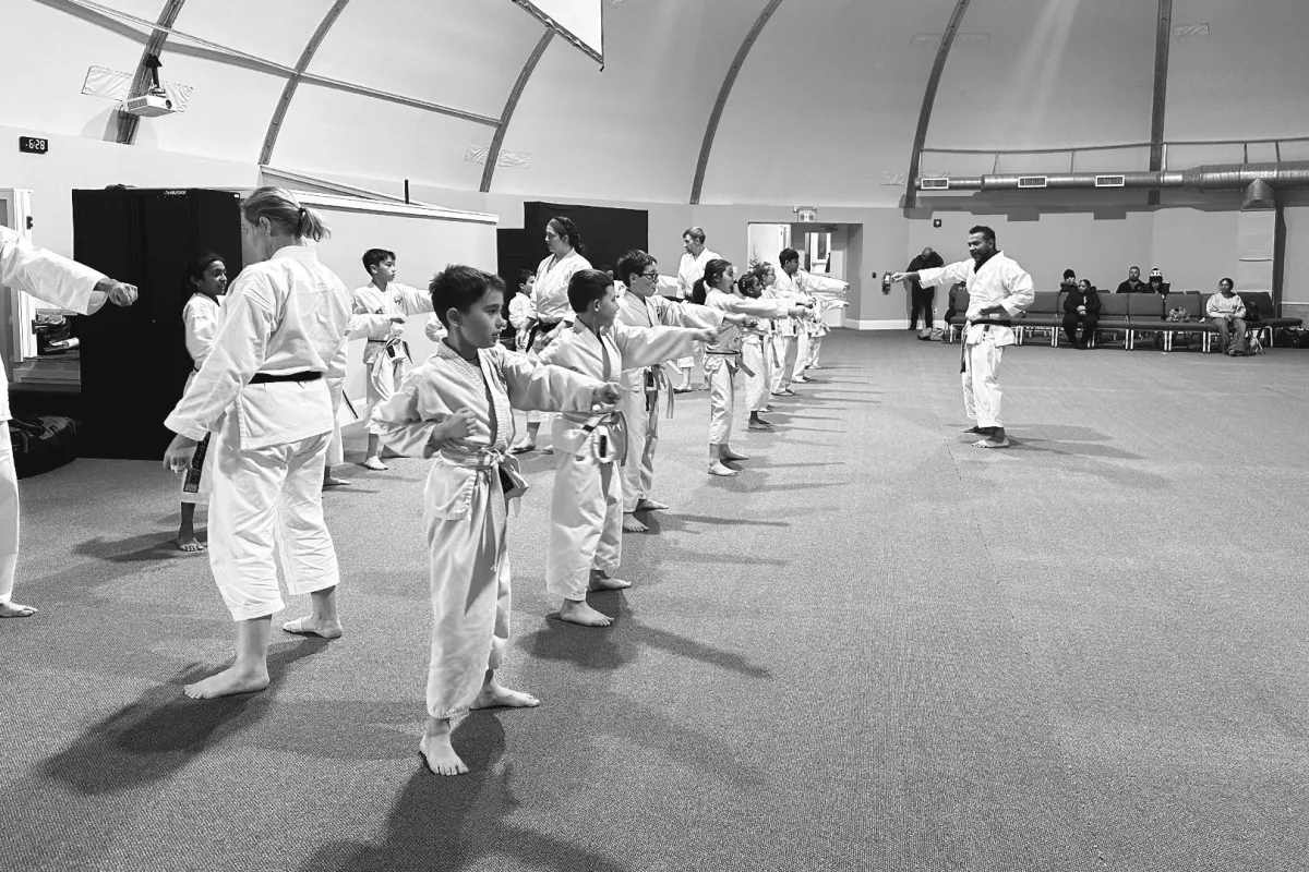 Energetic kids karate class at Rei Karate in Barrie, learning self-defense and valuable life skills through Rei.