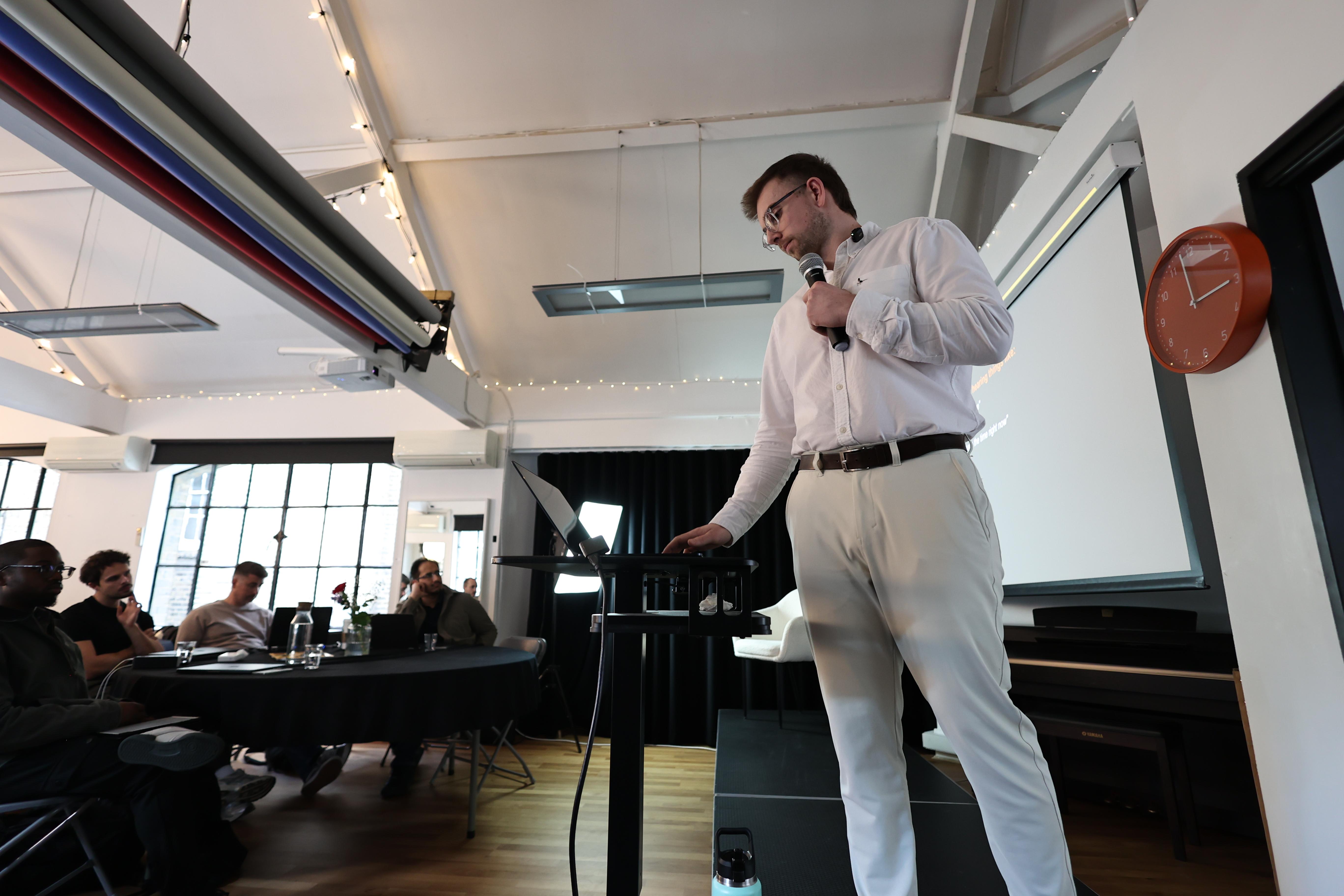Mark Tweed speaking on stage during sales training event
