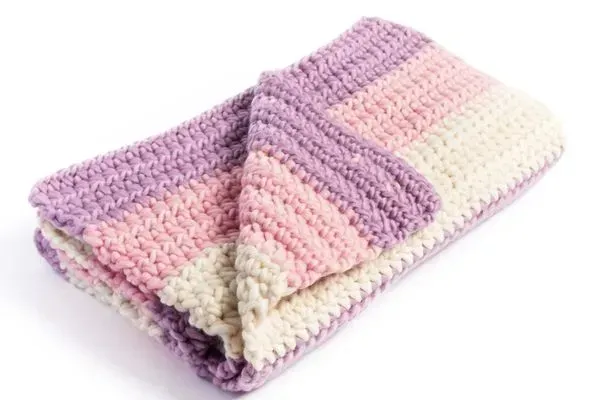 chunky knit handmade baby blanket made with merino wool in pink, lilac and cream