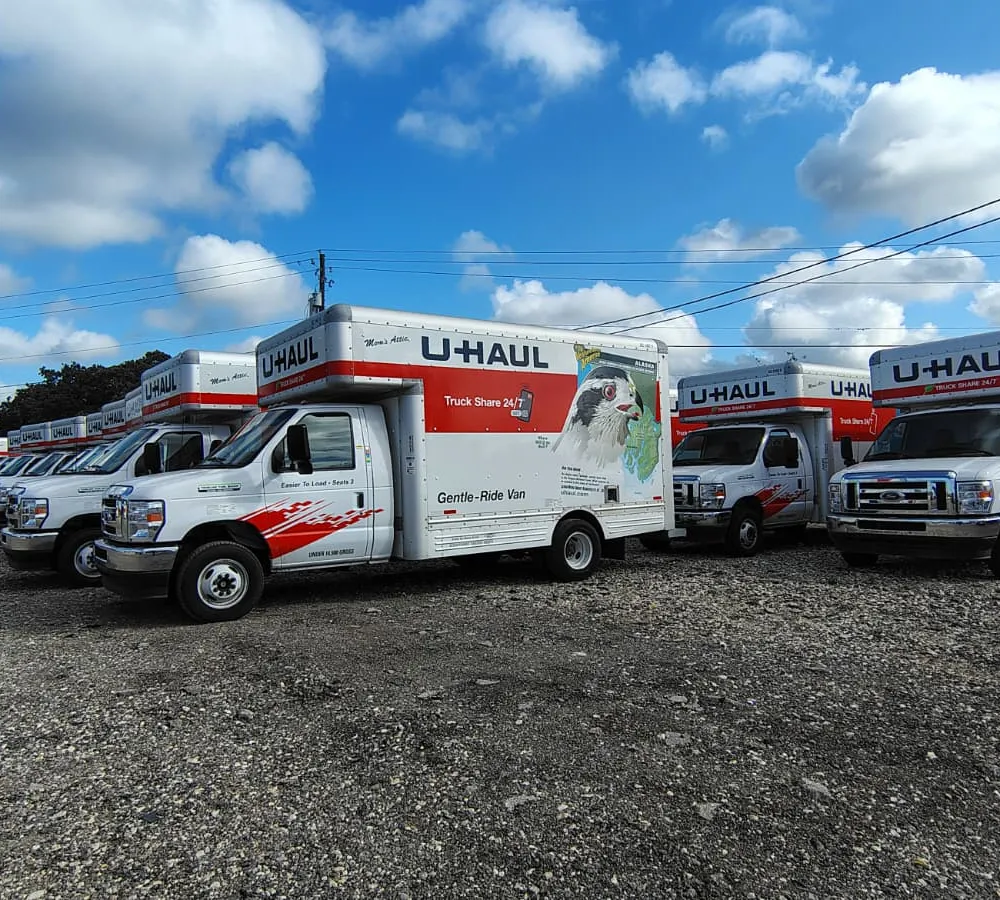 Organized U-Haul moving trucks, cargo trailers, and staging equipment ready for rental at Mega Space Location 1