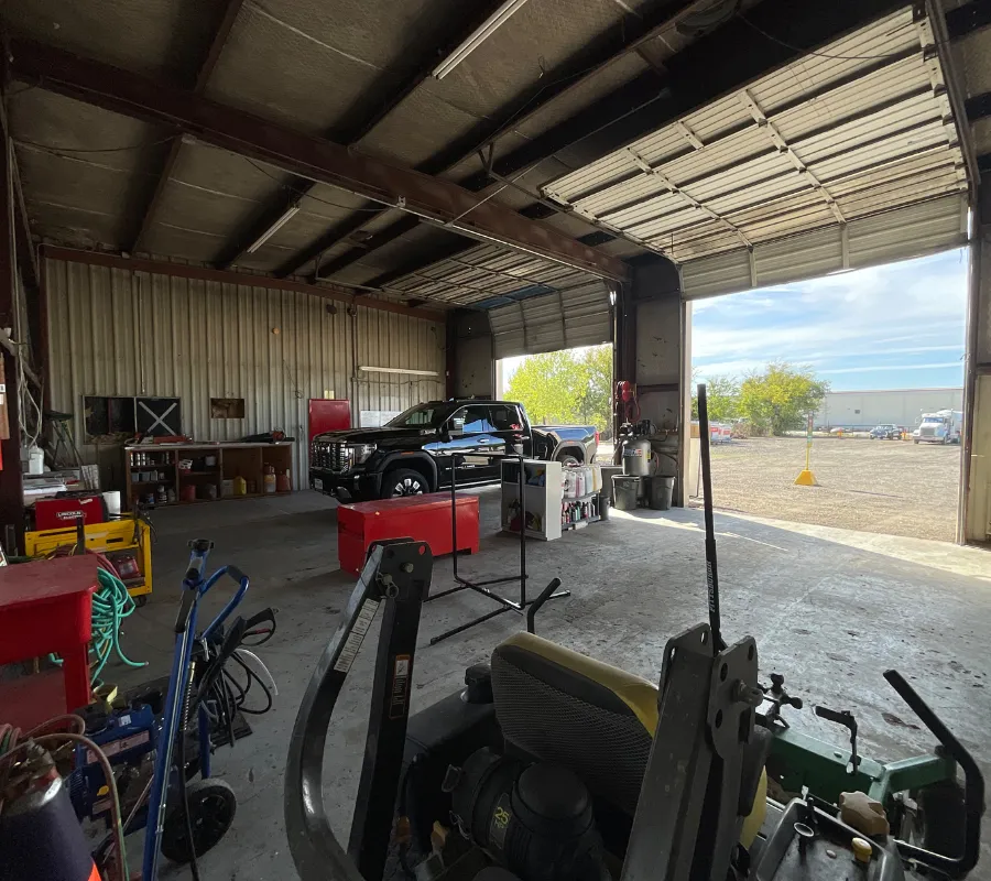 Row of premium rent-to-own portable buildings, utility sheds, and cabins staged on gravel lot at Location 2