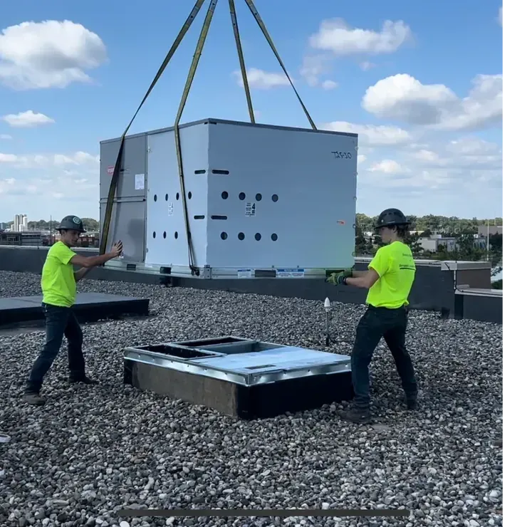 a tall building with a lot of windows next to trees