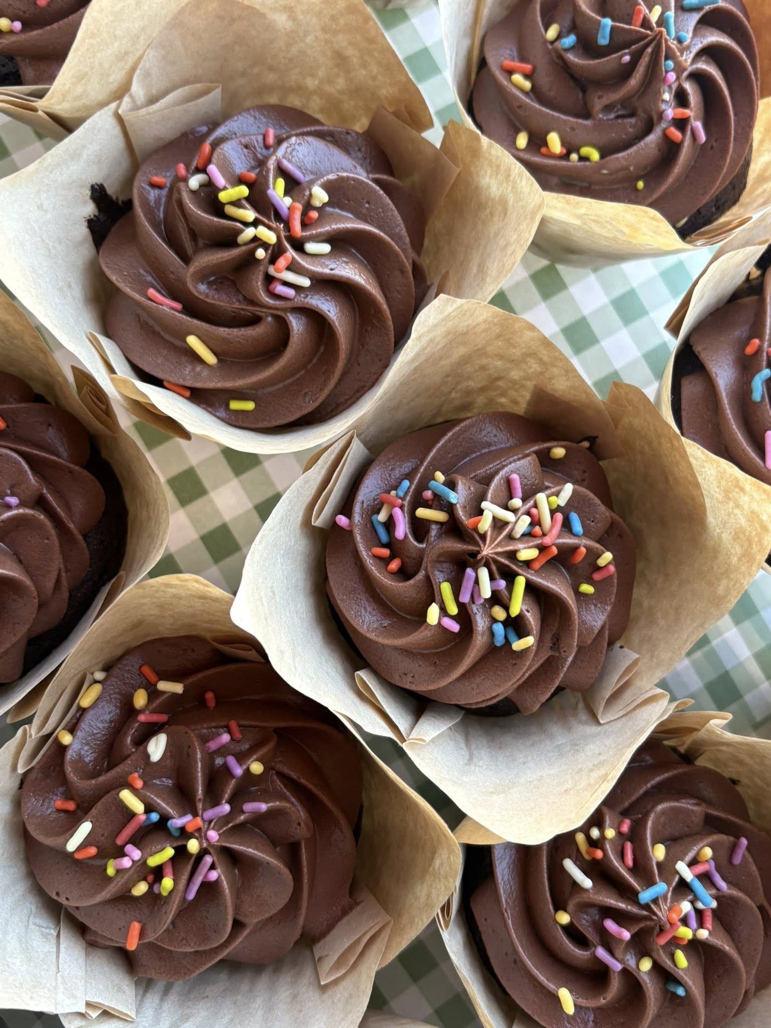 Square image of a cozy shop window with assorted pastries on display.