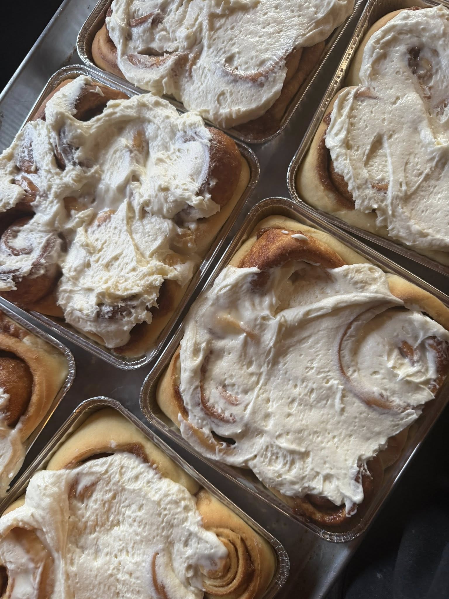 Square tile of a baker’s hands shaping dough, warm tones and close crop.
