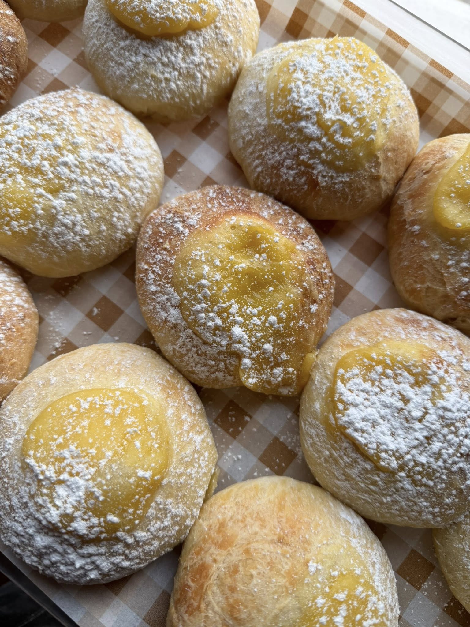 Square tile of a baker’s hands shaping dough, warm tones and close crop.