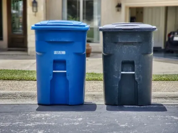 Residential trash and recycling bins placed curbside for pickup