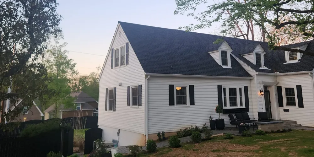 Roofing crew installing asphalt shingles during a roof replacement in Jackson, TN.