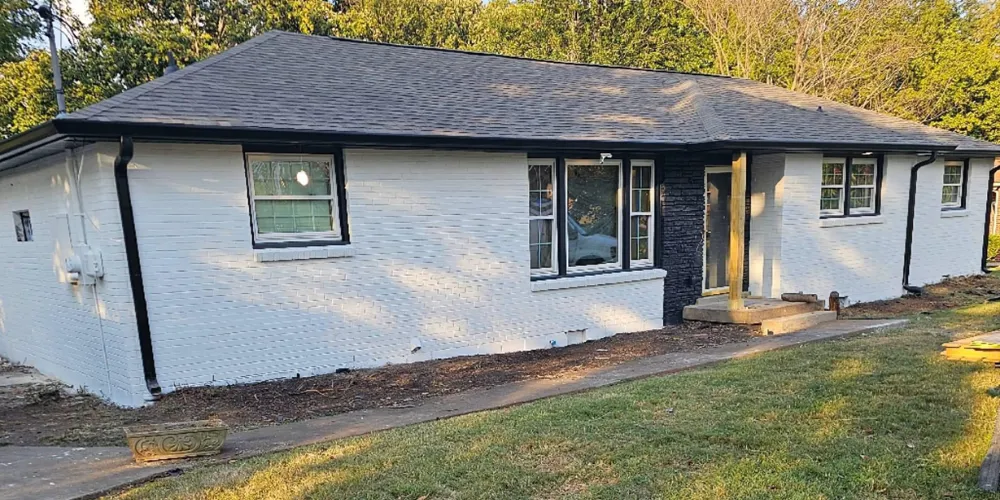 Roofing crew installing asphalt shingles during a roof replacement in Jackson, TN.