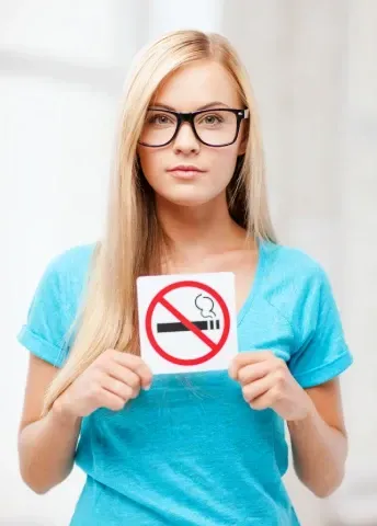 Girl with no smoking sign