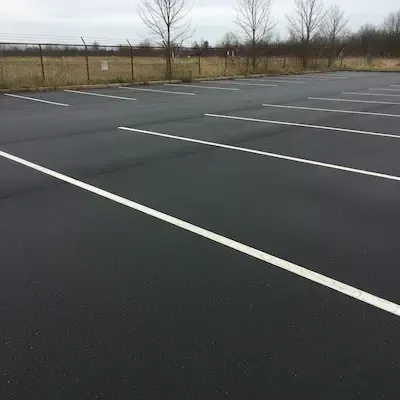 Commercial and multi-unit parking lot paving with proper drainage, layout, and a clean finished surface.
