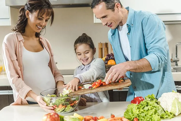 Family preparing a healthy meal together after receiving naturopathic care for metabolic and digestive health at Naturopathic Physicians Group in Scottsdale and Phoenix.