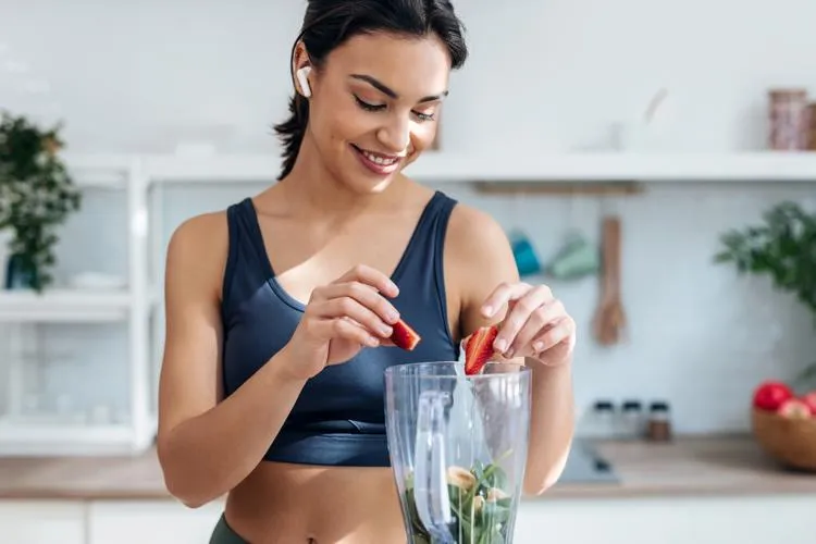 Woman preparing a healthy smoothie to boost immune health after naturopathic treatment at Naturopathic Physicians Group in Scottsdale and Phoenix.