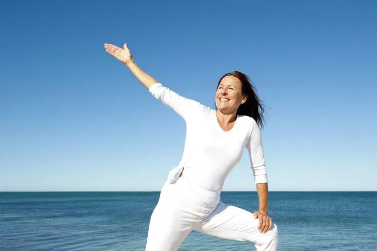 woman doing yoga demonstrating healthy aging thanks to Naturopathic Physicians Group