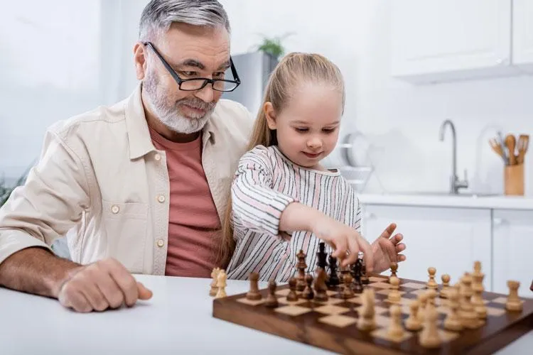 Grandpa playing chess with grandchild demonstrating mental and cognitive health thanks to Naturopathic Physicians Group in Scottsdale, AZ