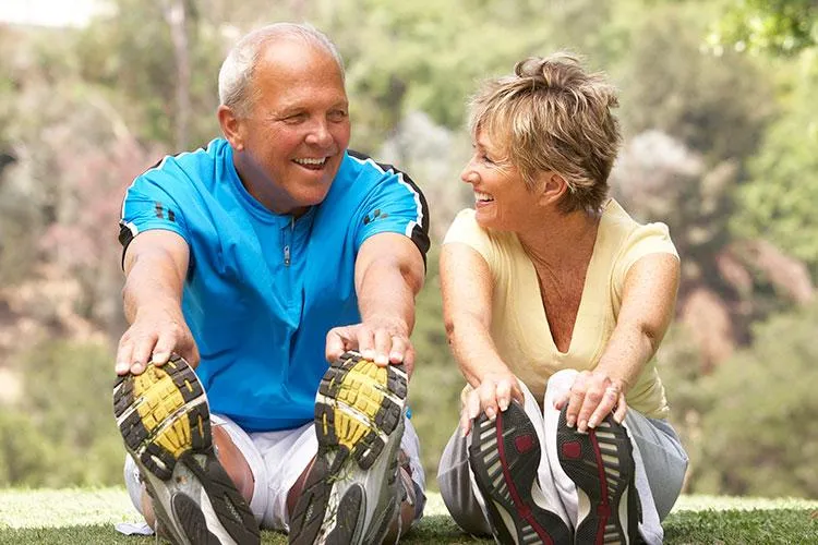 Healthy senior man and woman stretching in park after getting innovative therapies for whole-body healing at Naturopathic Physicians Group in Scottsdale and Phoenix,