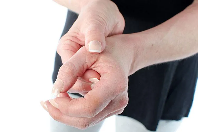 Woman hold hand with joint pain preparing for prolotherapy at Naturopathic Physicians Group in Scottsdale and Phoenix.