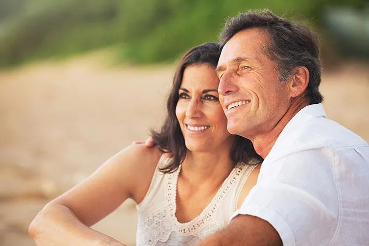 Mature couple sitting on beach after getting bio-identical hormone therapy Dr. Steven Katz and Dr. Loreena Ryder, naturopathic doctors at Naturopathic Physicians Group in Scottsdale and Phoenix, specializing in personalized care utilizing whole health assessments at Naturopathic Physicians Group in Scottsdale and Phoenix.