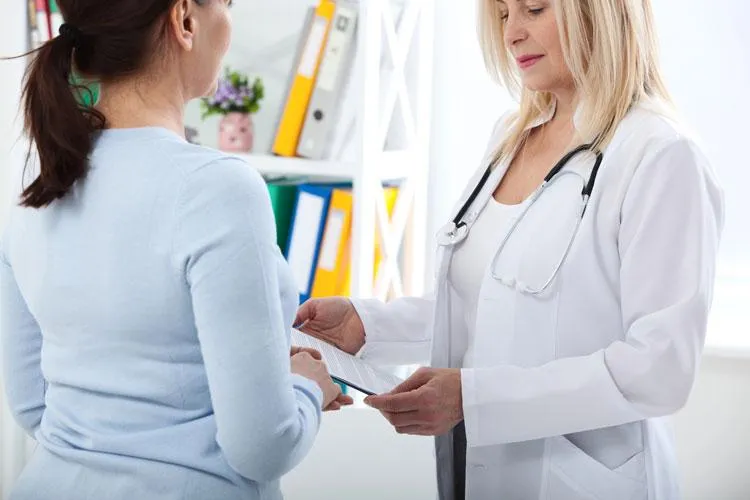 Female naturopathic doctor consulting with a patient, discussing personalized nutrient and botanical program options at a Scottsdale clinic.