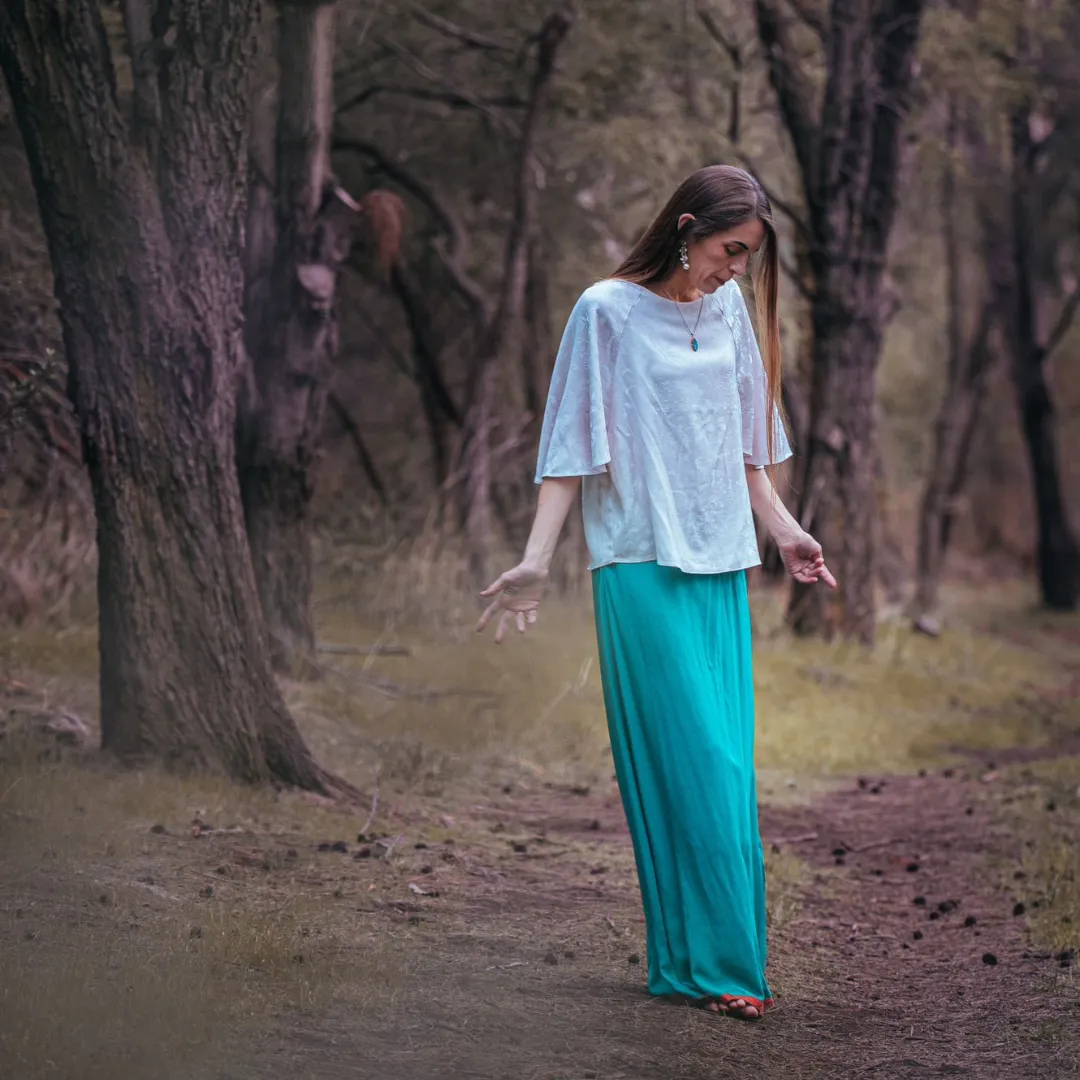 Sacred feminine figure framed by arches, roses, and golden light