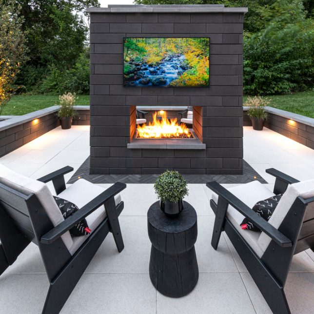 Custom outdoor fireplace and seating wall in Hinsdale, IL.