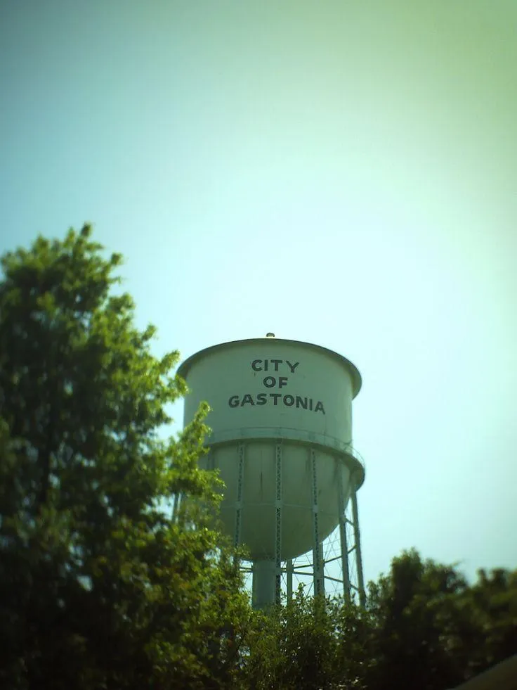 Aerial view of a modern cityscape with a large arena.