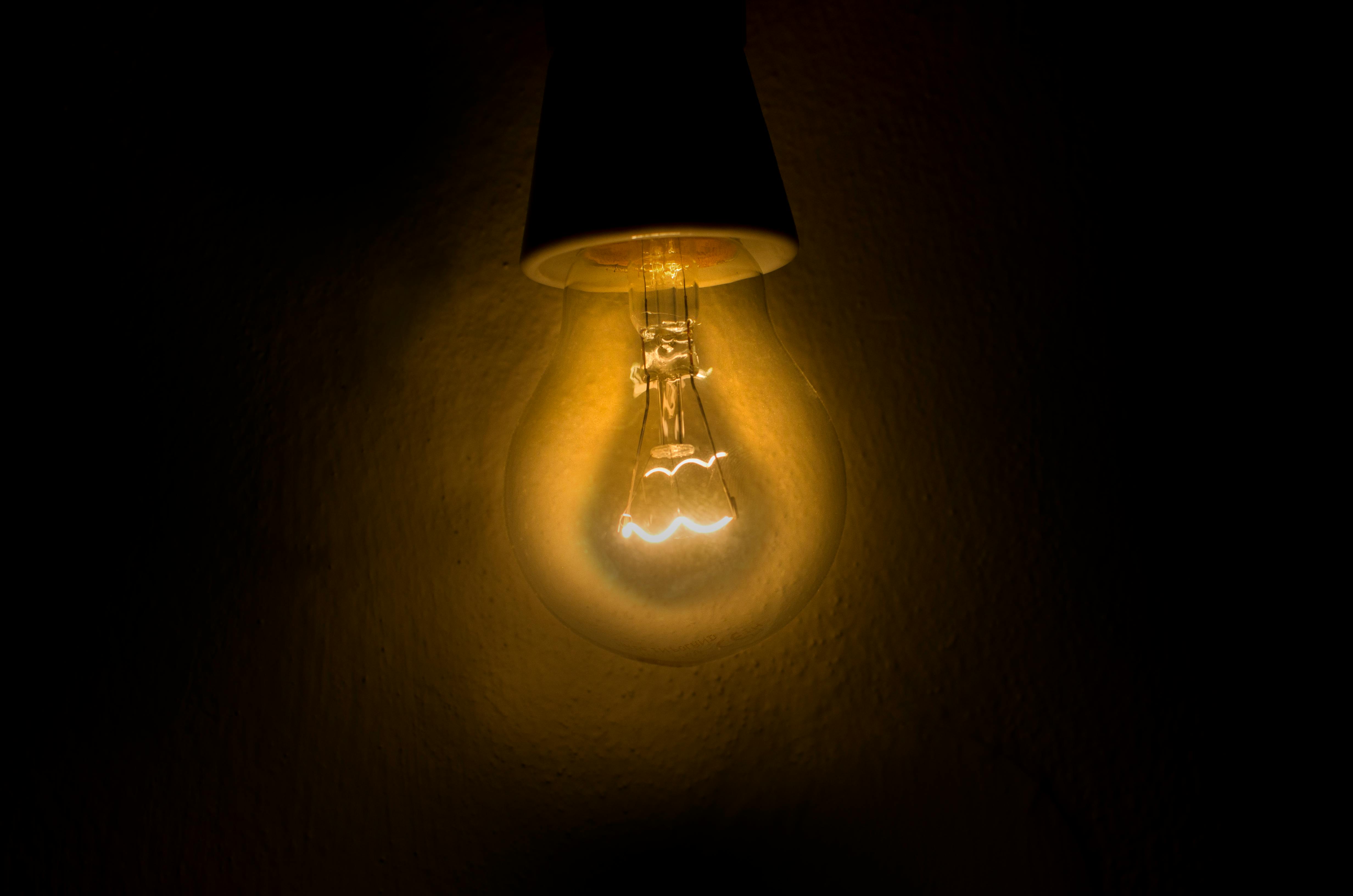 A glowing vintage lightbulb against a dark background