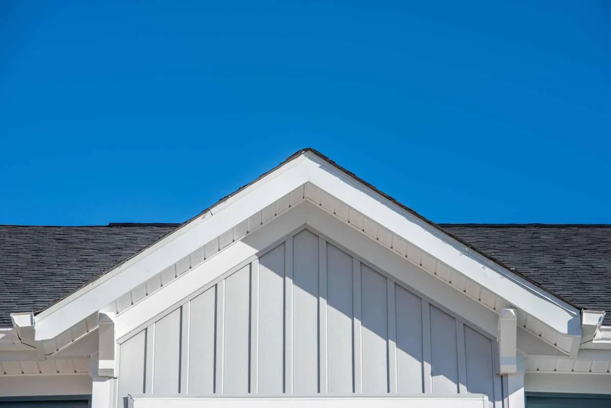 White fascia on front of home in Windsor Ontario with blue sky in background