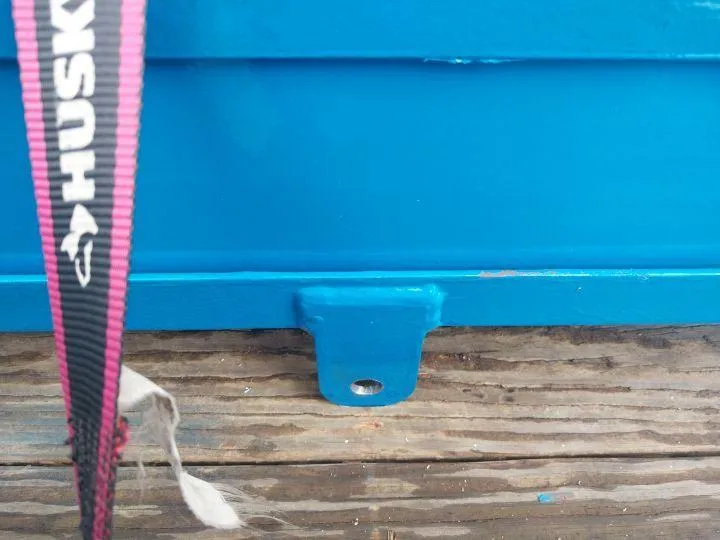 Custom fabricated blue metal bracket for marine or trailer support by Warrior Welding