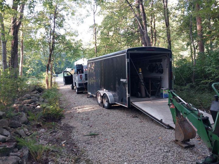 Fully equipped mobile aluminum welding trailer at off-site job location in New Hampshire woods