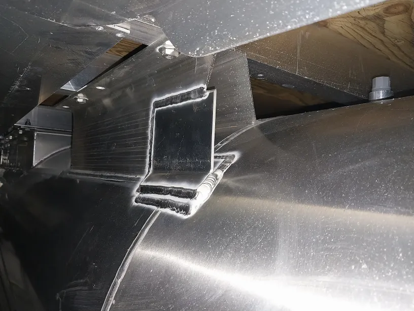 Mobile aluminum welding truck inside indoor boat storage facility in New Hampshire