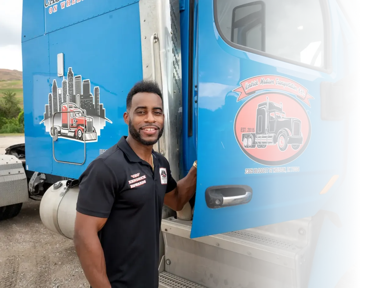 Kendrick from CashFlow on Wheels standing next to blue semi