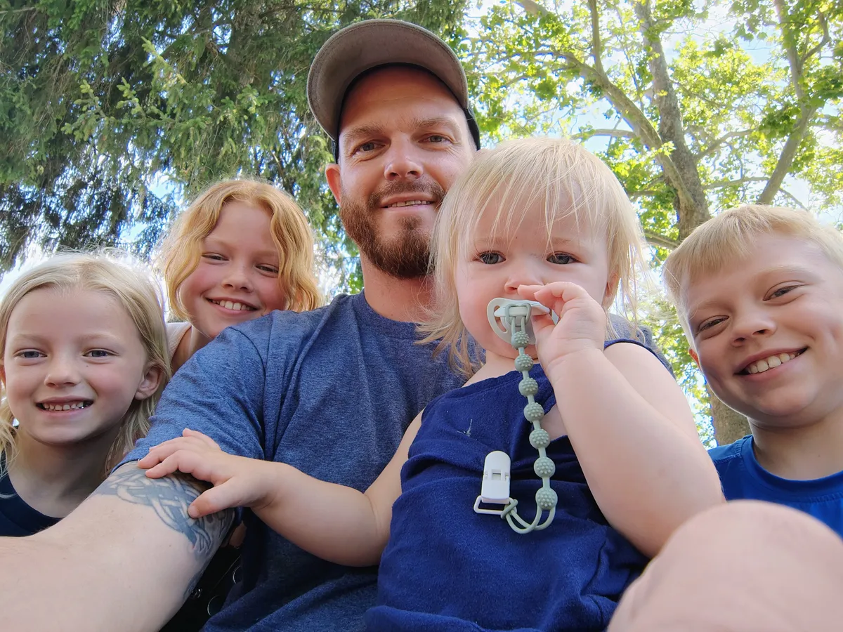 JC Hydro Blast owner Jason and his four children smiling outdoors together in West Michigan.