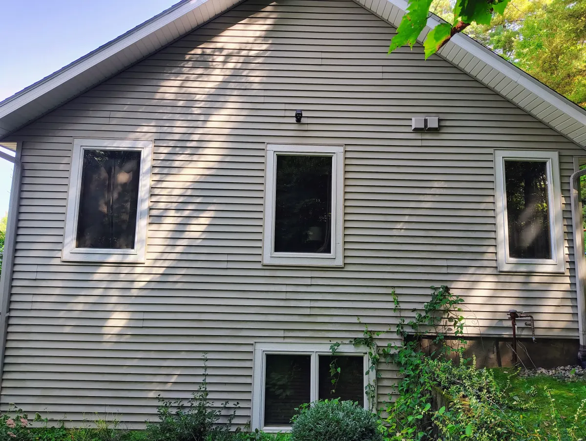 Spotless vinyl siding, gutters, and fascia after professional soft wash cleaning.